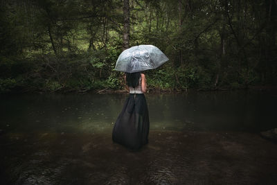 Rear view of a woman in the forest