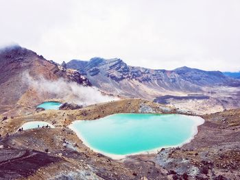 Scenic view of lake on mountains against sky