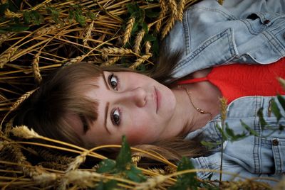 Portrait of young woman lying on grass