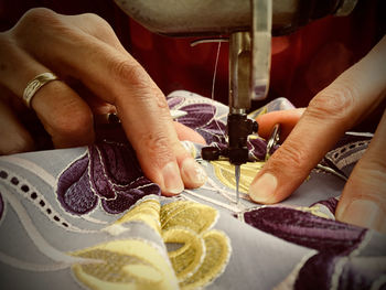 Close-up of hand sewing at home