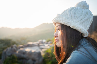 Portrait of woman looking at mountains