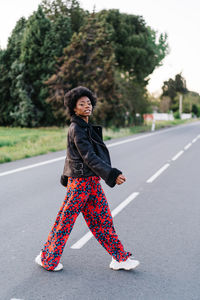 Portrait of smiling girl on road in city