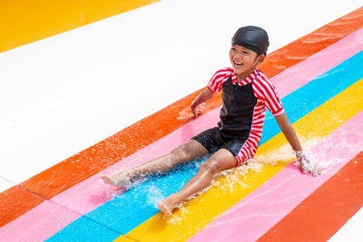 Full length of girl standing in swimming pool