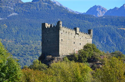 Castle on mountain against sky