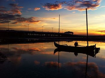 Reflection of clouds in sea at sunset