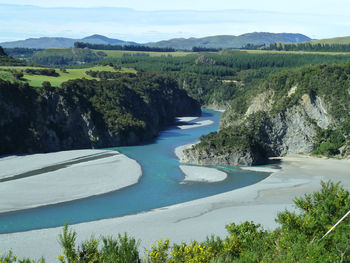 High angle view of river amidst trees against sky