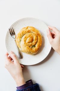 Cropped hand of person holding food on table