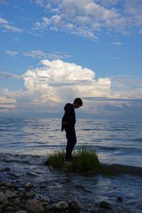 Man standing on beach against sky