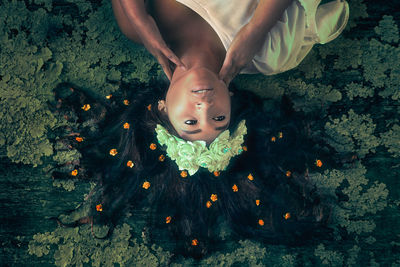 High angle view of young woman wearing flowers