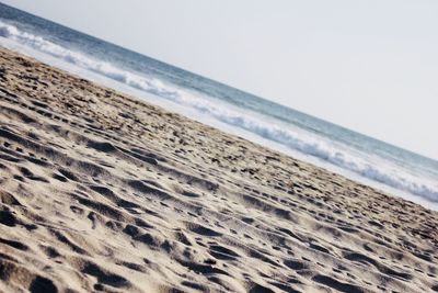 Scenic view of beach against clear sky