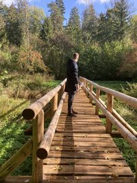 Full length of man walking on footbridge
