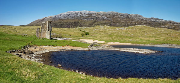 Scenic view of land against clear blue sky