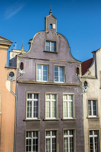 Low angle view of building against blue sky
