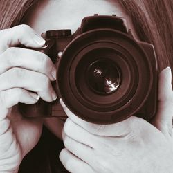 Close-up of woman holding camera