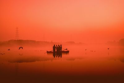 People on a boat at dawn in new delhi