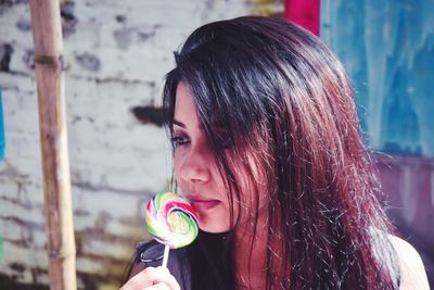 Close-up of beautiful woman with lollipop