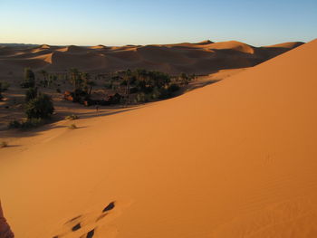 Scenic view of desert against sky during sunset