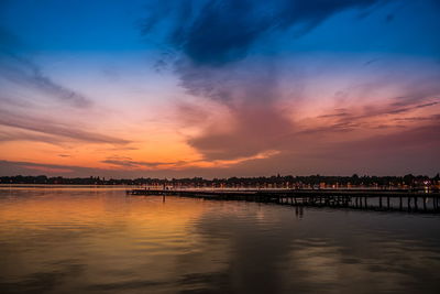 Scenic view of lake against romantic sky at sunset