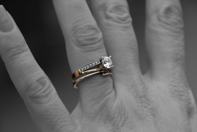 Midsection of person holding wedding rings