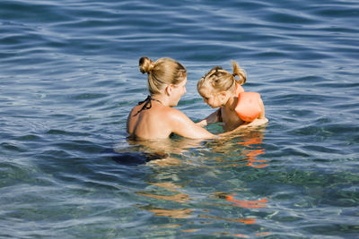 Young woman swimming in sea