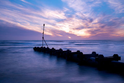 Scenic view of sea against sky at sunset