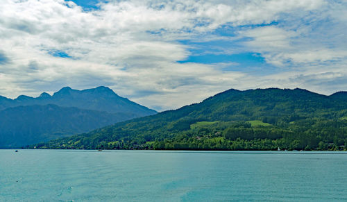 Scenic view of sea and mountains against sky