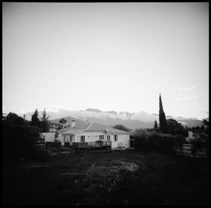 Houses by building against clear sky