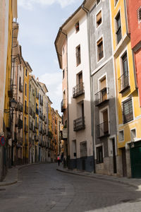 Street amidst buildings in city against sky