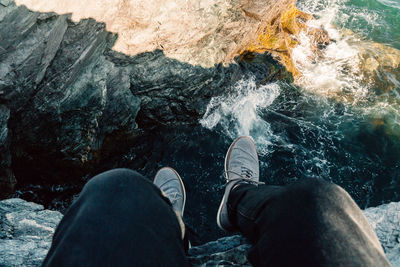 Low section of person standing in water