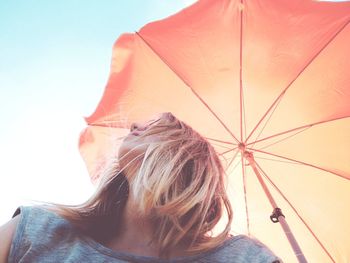 Low angle view of woman with umbrella