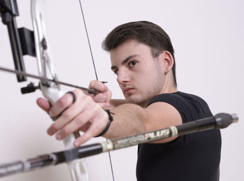 Young man holding bow and arrow