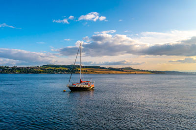 Sailboat on sea against sky