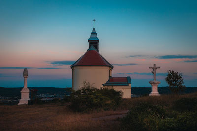 Lighthouse by sea against sky
