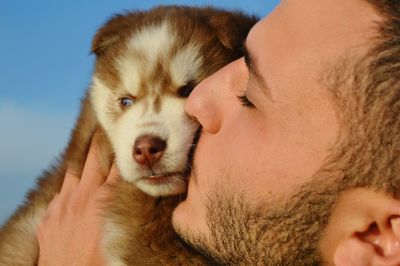 Close-up of man kissing pet dog