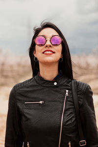 Portrait of beautiful woman while standing outdoors