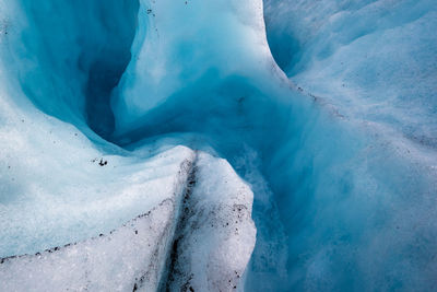 Low section of person on snow covered landscape