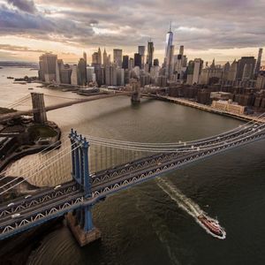 View of manhattan and brooklyn bridge over river in city
