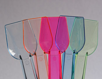 Low angle view of multi colored glass against white background