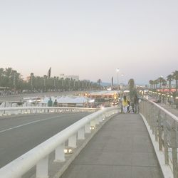 People walking on bridge over river