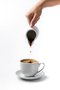 Close-up of coffee cup over white background