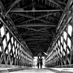 Rear view of man walking in tunnel