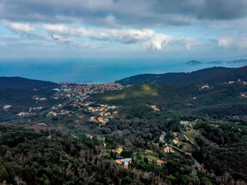 High angle view of landscape and sea against sky