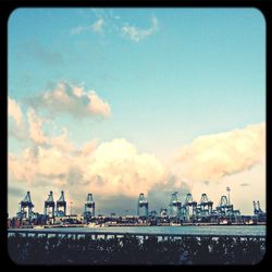 View of harbor against cloudy sky