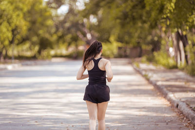 Rear view of woman standing outdoors