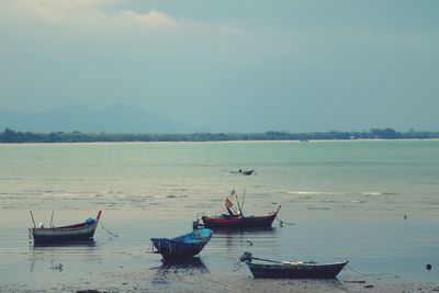 Boats on sea against sky