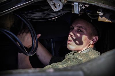 Soldier sitting in military vehicle