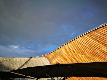 Low angle view of building roof against sky