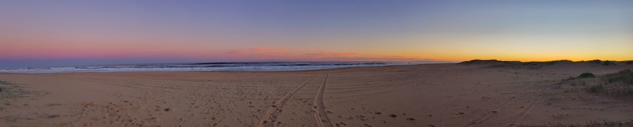 Scenic view of beach against sky during sunset
