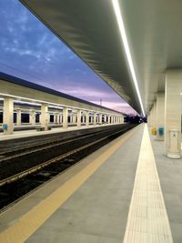 Train at railroad station against sky