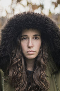 Close-up portrait of young woman in winter
